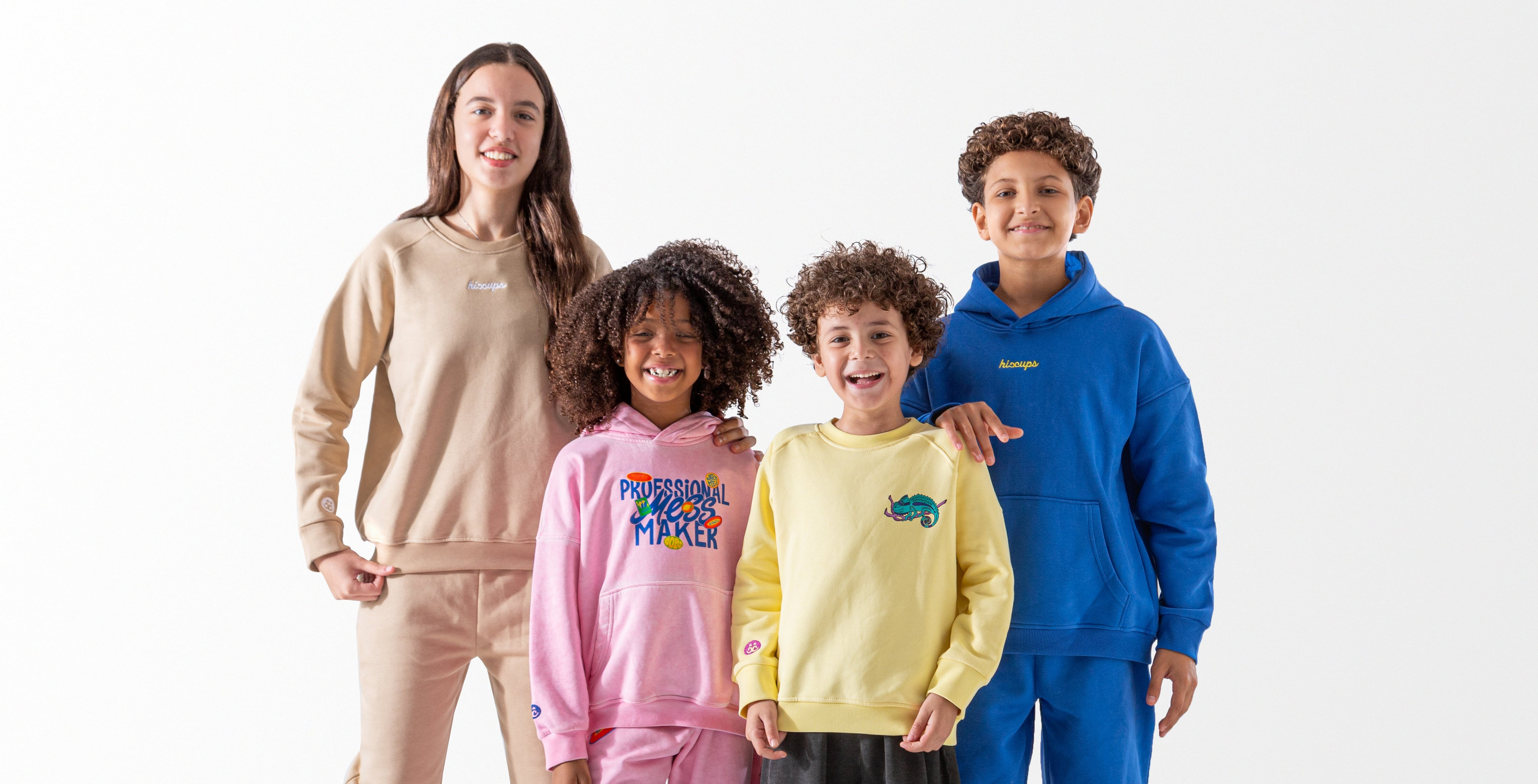 Four children wearing colorful sweatshirts with visible brand logos on a white background